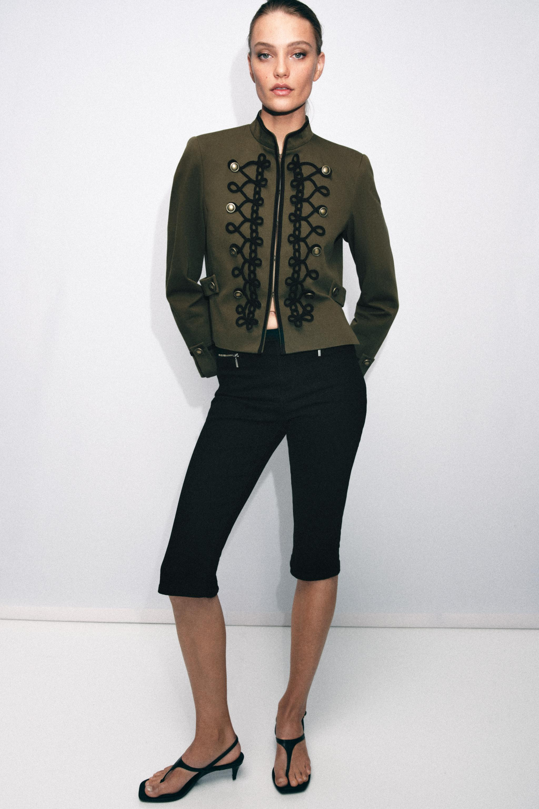 High neck long sleeve blazer with shoulder pads. Hem with side vents and tabs. Front hidden hook ... | Zara US