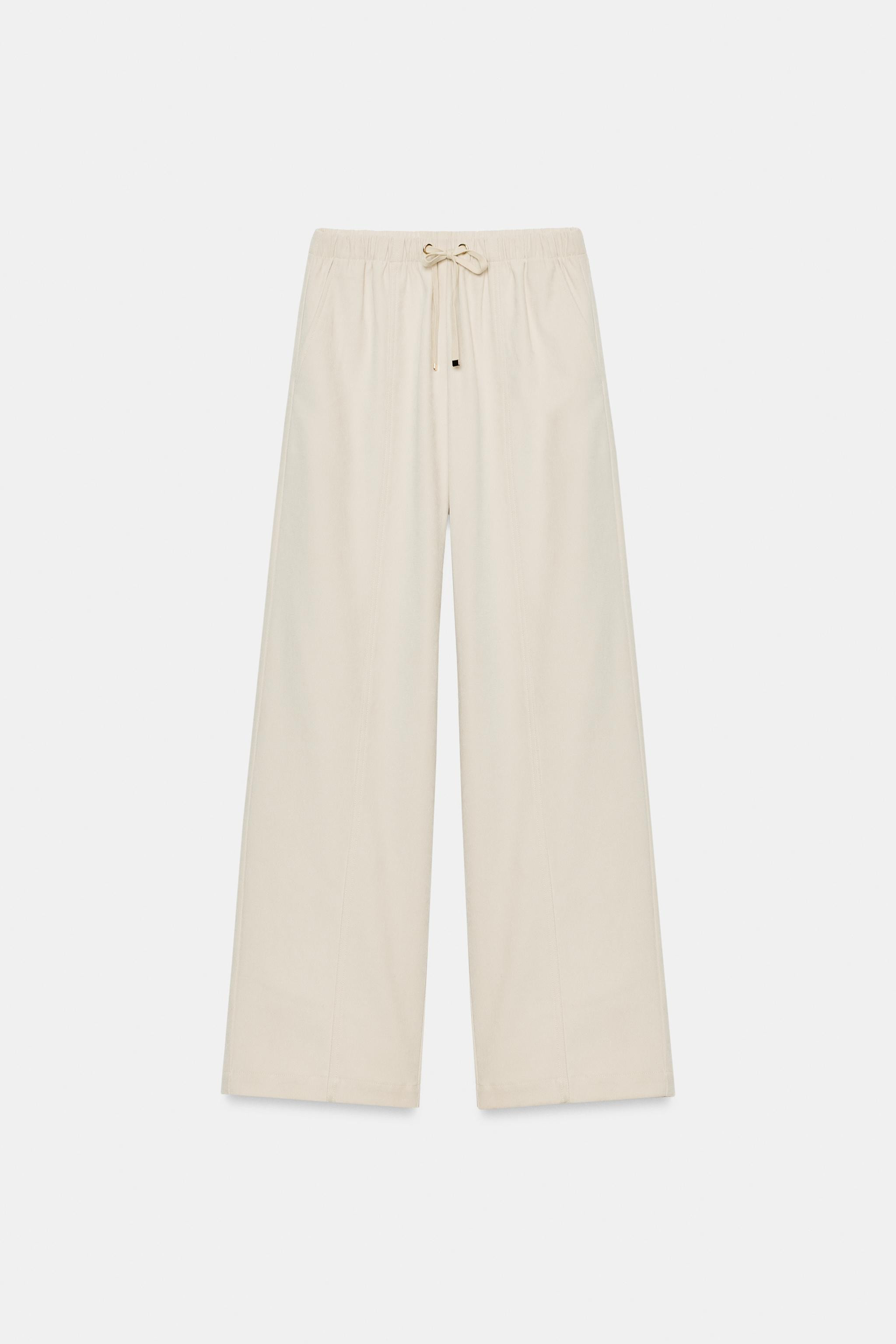 High-waist trousers with an elastic drawstring waistband. Front pockets and false welt back pocke... | Zara UK