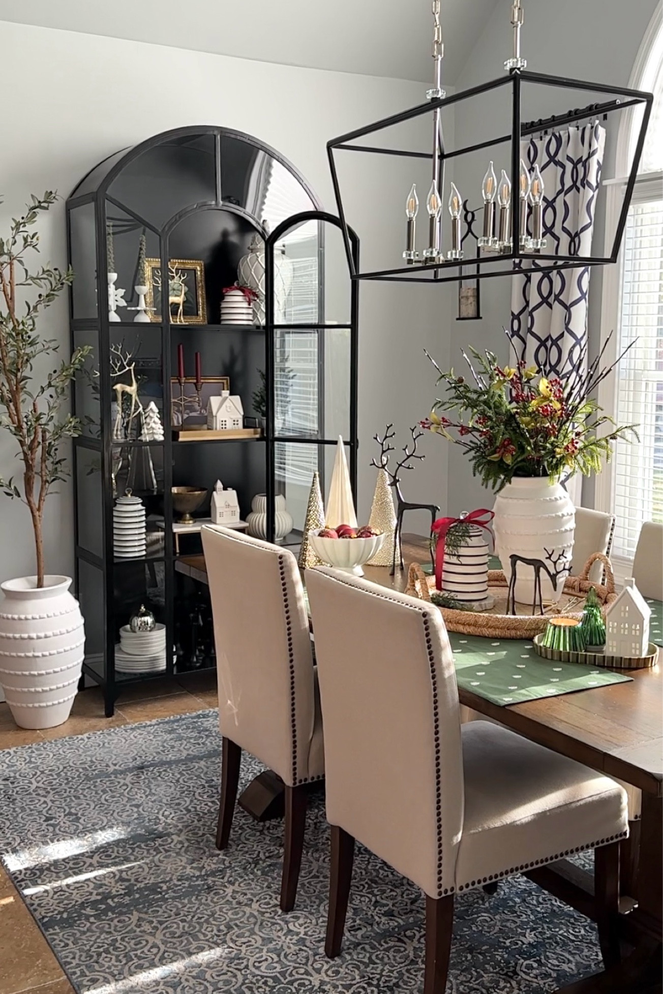 Holiday, Christmas dining room. Shop black display cabinet, lighted stems, greenery, faux berry stems, large textured vase, canisters, bronze reindeer, brass reindeer, holiday table trees, candles, trays. Dining room table and chairs Crate & Barrel, Pottery Barn, Target, Wayfair. Holiday, Christmas styling, free shipping. 

#LTKHoliday #LTKHome #LTKFindsUnder50