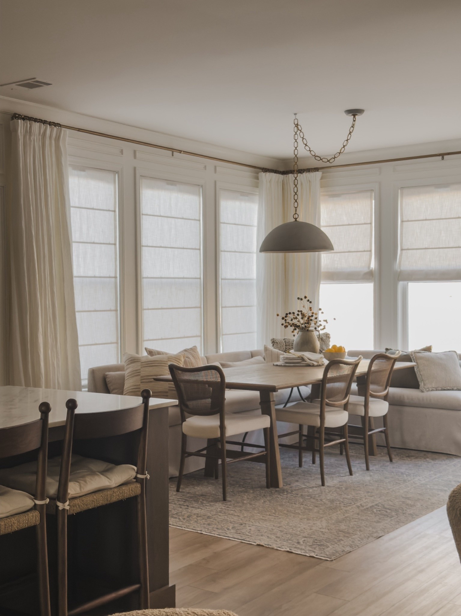 One of my must haves in my new home was a cozy breakfast nook complete with a banquette! I love that everyone naturally gravitates to the space, even the dogs! It gives such a cozy but timeless feel.

Home finds, neutral home inspo, breakfast nook, collected style, swag lights, furniture favorites, neutral wood tones, dining chair, counter stool, banquette seating, dining table, neutral area rug, vintage style area rug, linen curtain, roman shades, brass detail, rich wood tones, faux florals, cozy throw pillow, Amber Lewis, Loloi, Wayfair, Arhaus, Home and Kids Co, Visual Comfort, Pottery Barn style, Two Pages, shop the look!

#LTKHome #LTKSeasonal