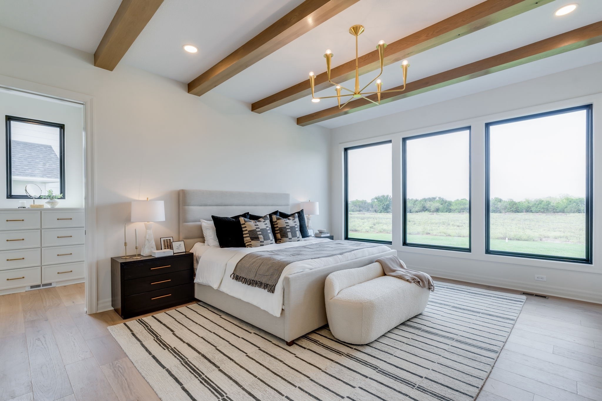 A dreamy neutral bedroom. 🤍
This space is styled with an upholstered bed, cozy layered bedding, and a chic mix of black nightstands and neutral nightstand lamps. A bouclé accent bench adds softness at the foot of the bed, while a striped area rug grounds the space. Finished with wood ceiling beams and a modern gold chandelier, this room is the perfect blend of organic luxury and timeless comfort.

#LTKhome #LTKhomedecor #LTKstyletip #bedroomdecor #neutralbedroom #modernbedroom #bedroomfurniture #upholsteredbed #nightstandstyle #bedroomlighting #goldchandelier #bouclebench #stripedrug #woodceilingbeams #neutralhomedecor #organicluxuryliving #cozybedroom #styledspaces #interiorstyling #LTKhomeinspo

#LTKStyleTip #LTKHome #LTKFamily