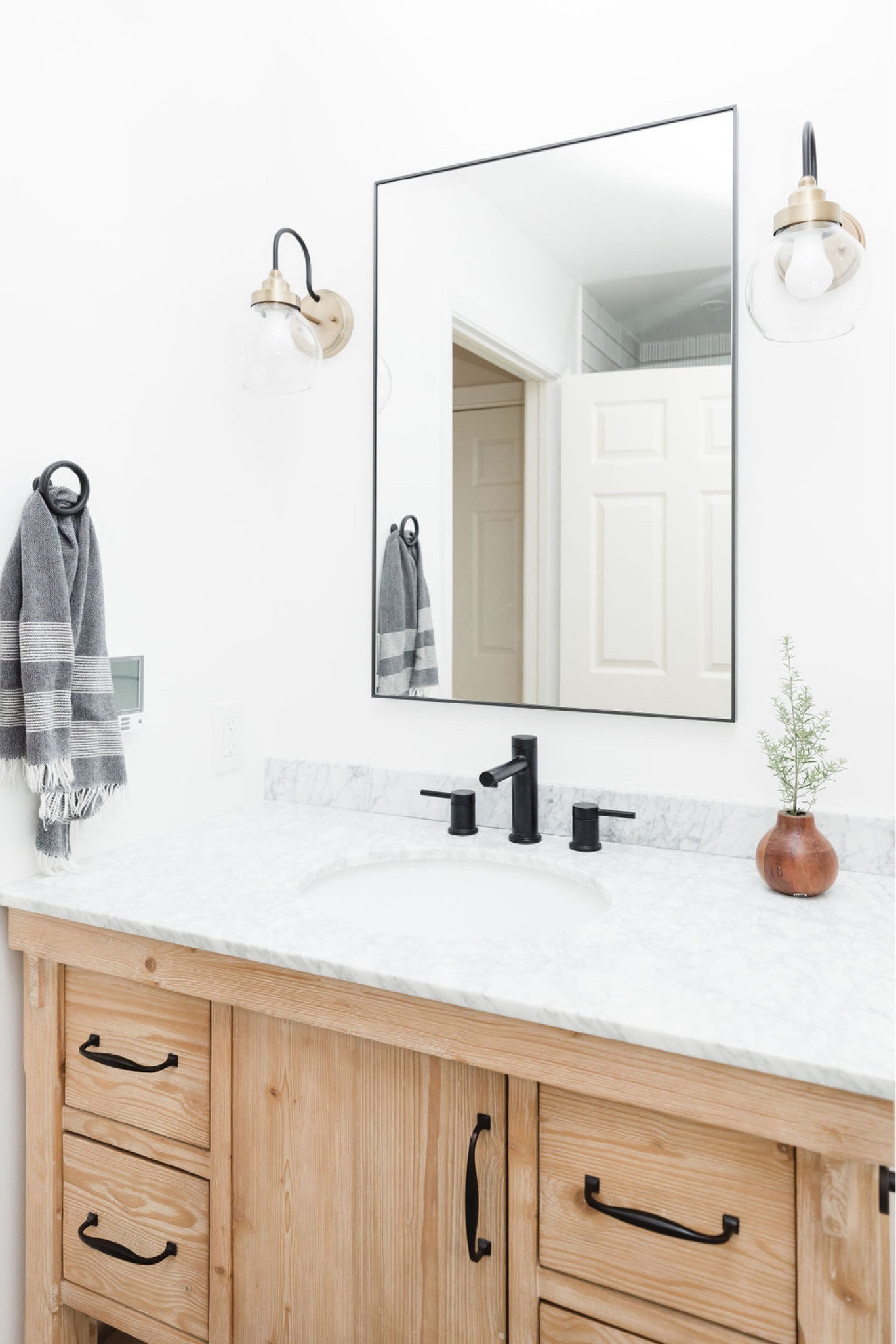 Fresh bathroom with sleek, unassuming medicine cabinet with modern fixtures balance with a wood vanity for a clean look. 

Bathroom, bathroom vanity, sconce.

#LTKhome #LTKunder100