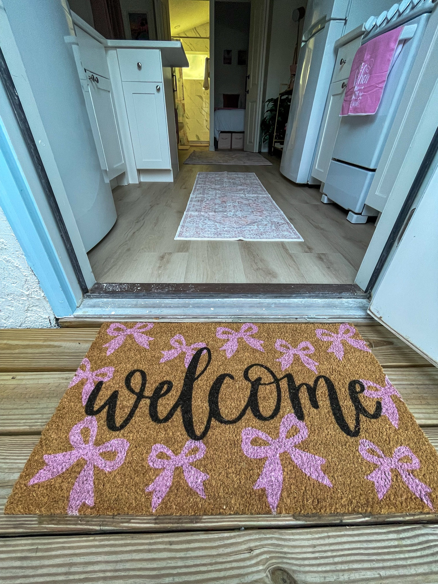 The cutest welcome mat to greet every guest with pink bows.