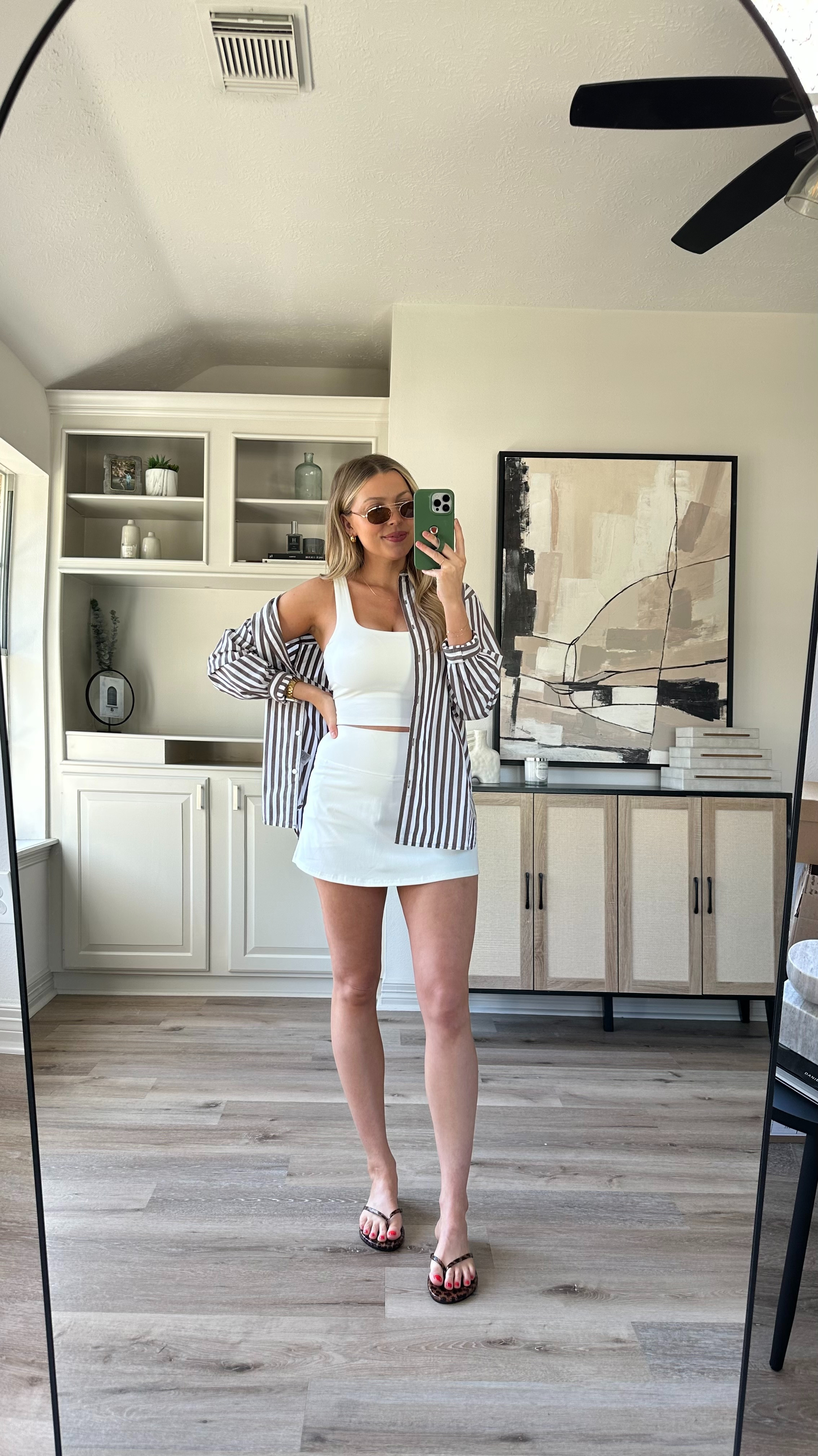 Casual Spring Outfit | This athletic skort is my favorite! It feels so similar to another brand. Wearing size M in the skort, white top, and striped button up. Sandals fit tts. 

 

#LTKActive #LTKStyleTip