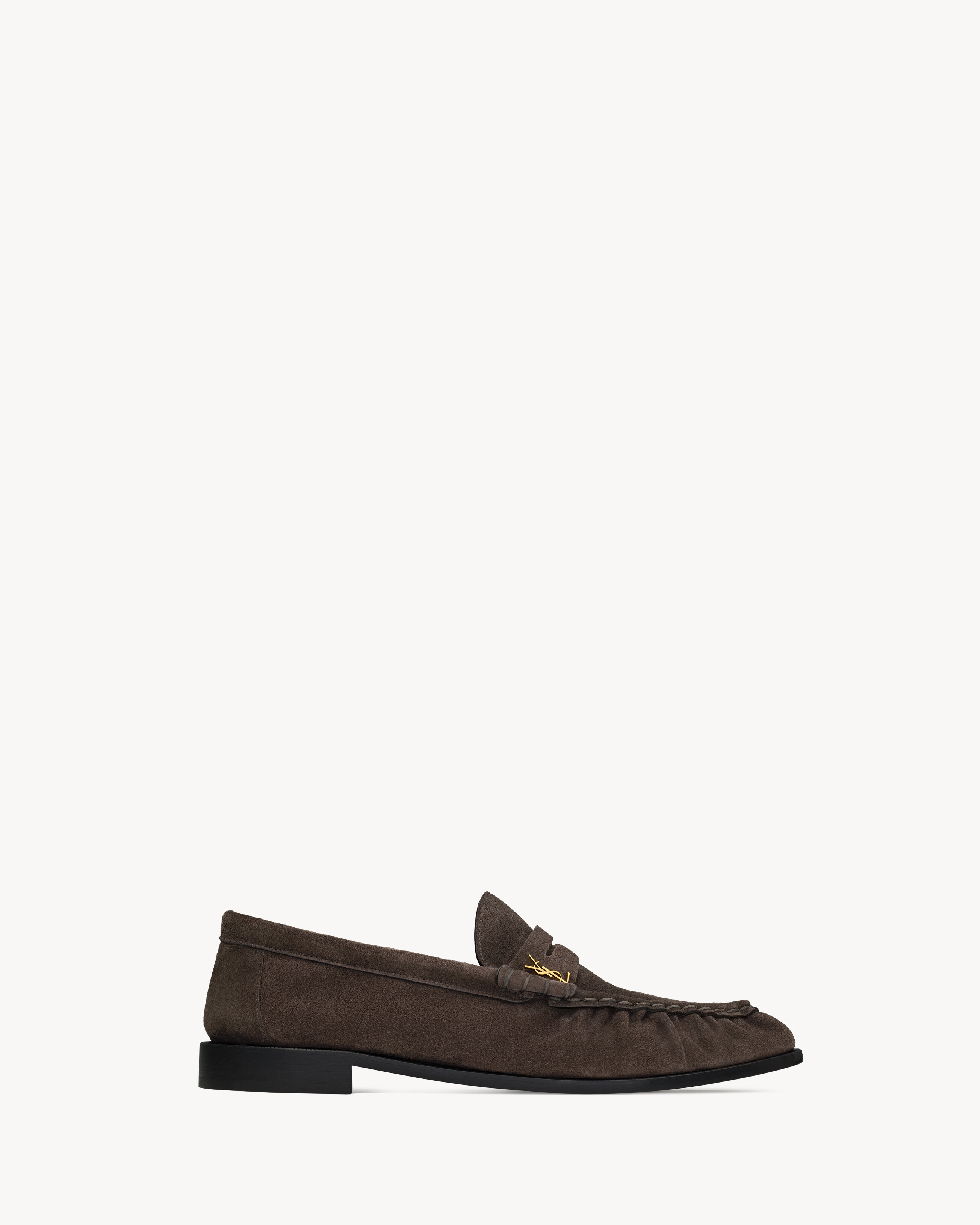 supple penny loafers decorated with the CASSANDRE, featuring a hand-stitched moc toe. | Saint Laurent Inc. (Global)