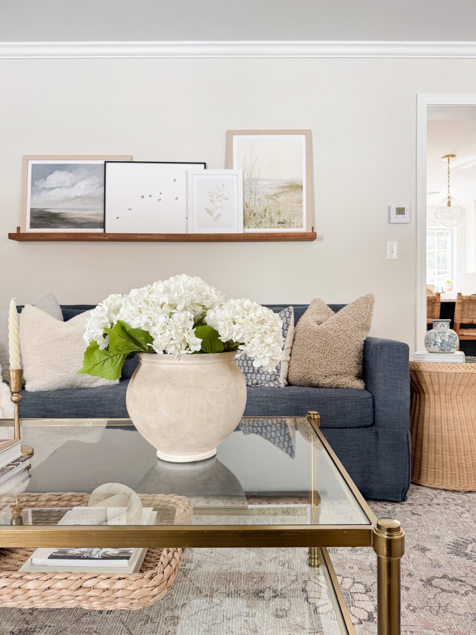 Coastal living room styled with neutral throw pillows, textured ivory rug, faux florals, and layered sofas for a relaxed high end coastal look.

coastal living room decor,  neutral sofa styling, coffee table florals, light coastal interiors, sherricalnanhome

#LTKHome