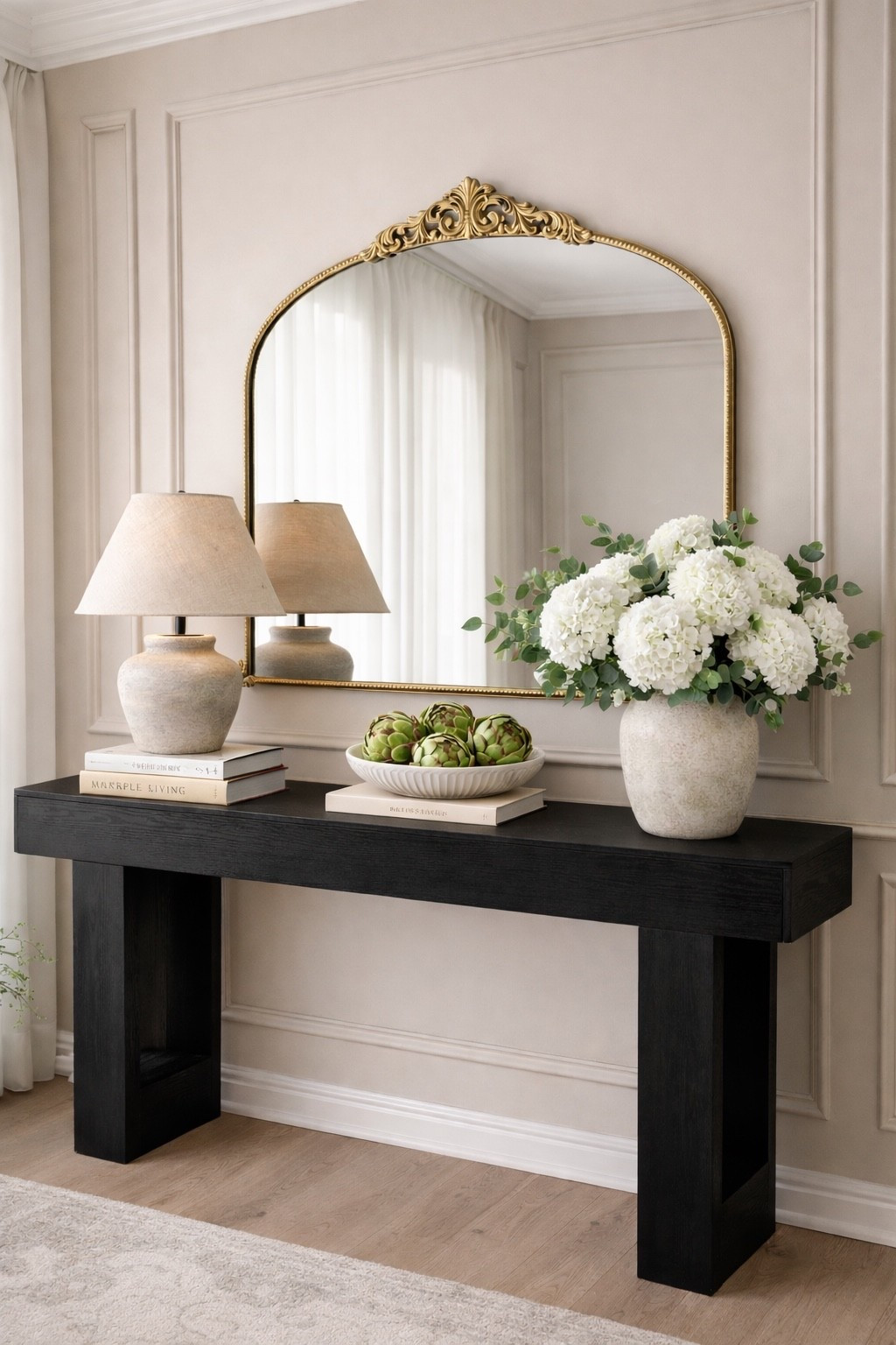 Simple, neutral, and effortlessly elevated ✨

Sometimes all it takes is a beautiful mirror, soft florals, and a touch of green to make a space feel calm and intentional. I swapped the moss balls for artichokes and I love how organic and European it feels now 🤍

This little corner makes our home feel warm, styled, and still very us 🏡