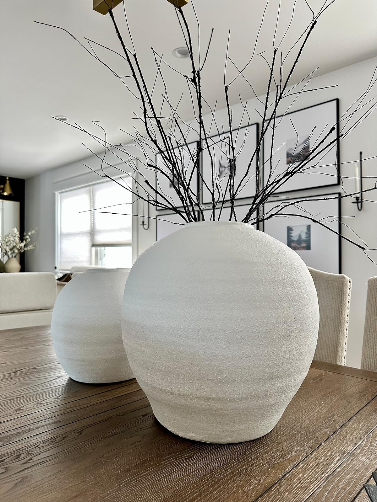 White modern organic vases, black willow branches, gallery wall frames. Gold modern chandelier, black candle scones. | Amazon (US)