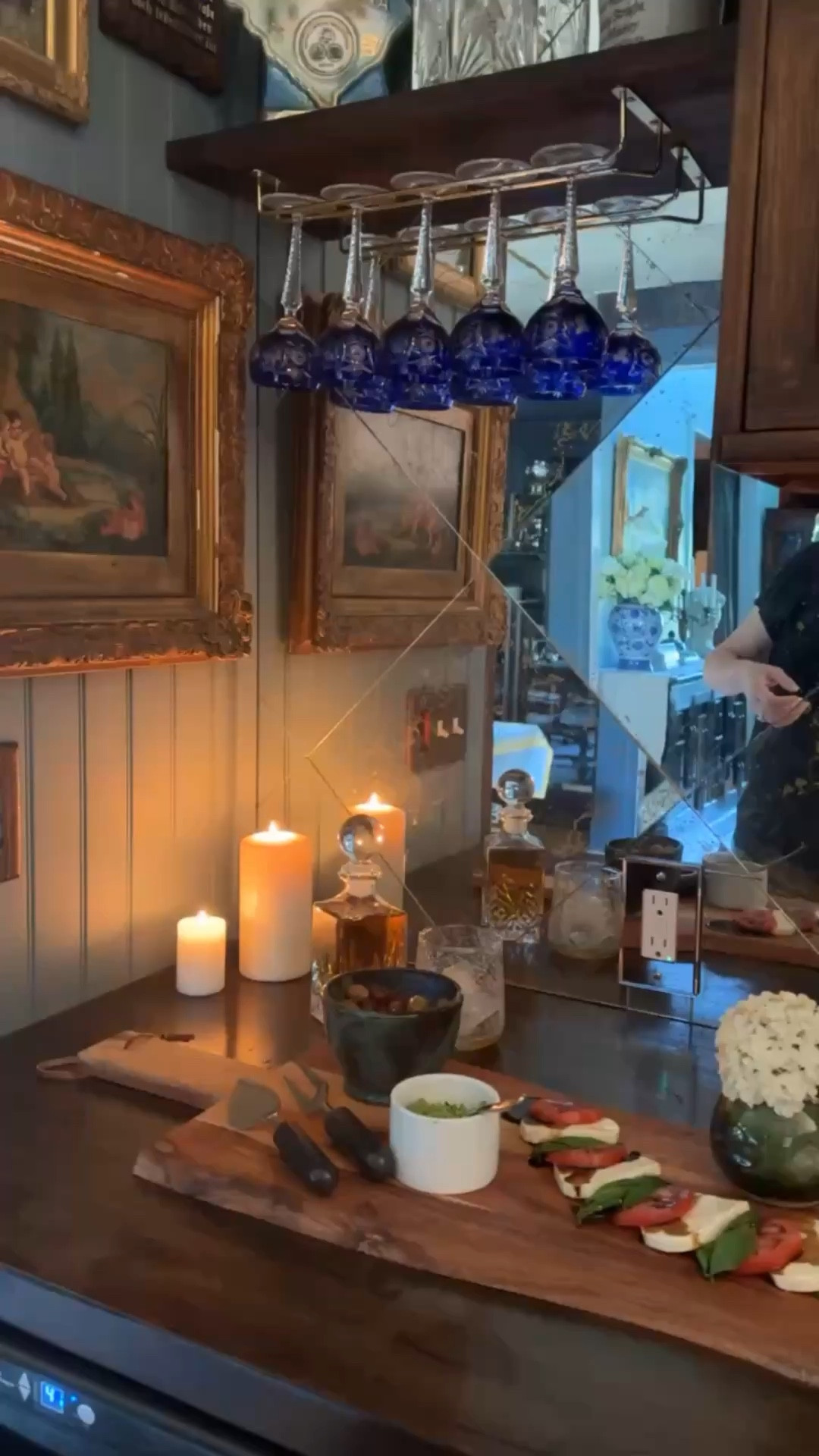 A relaxing bar space layered with glow and texture. Cobalt wine glasses, an etched decanter, mirror tile backsplash, and a candlelit charcuterie setup come together to create an atmosphere that feels rich, inviting, and made for lingering. 🕯️💙🥃

 #HomeBar #CobaltGlass #EtchedGlass #MoodyInteriors #EntertainingAtHome #CharcuterieBoard #TimelessStyle #HomeDecor #DesignDetails #callsigndesign