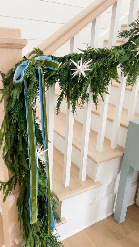 Christmas garland on our staircase this year! Loving the real touch Norfolk pine garland layered with this faux cypress garland. The white starburst ornaments are a fun touch paired with the blue and green velvet ribbon! Also linking our blue console table in our entryway.
.
#ltkhome #ltkholiday #ltksalealert #ltkfindsunder50 #ltkfindsunder100 #ltkover40 #ltkstyletip #ltkseasonal #ltkvideo

#LTKVideo #LTKHoliday #LTKhome