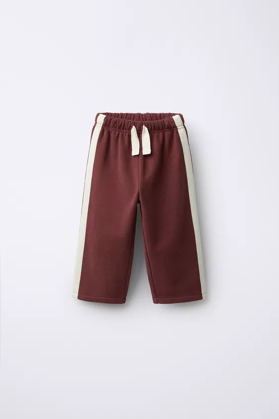 Plush pants with elastic waistband and adjustable front drawstring. Contrasting color stripe deta... | Zara US