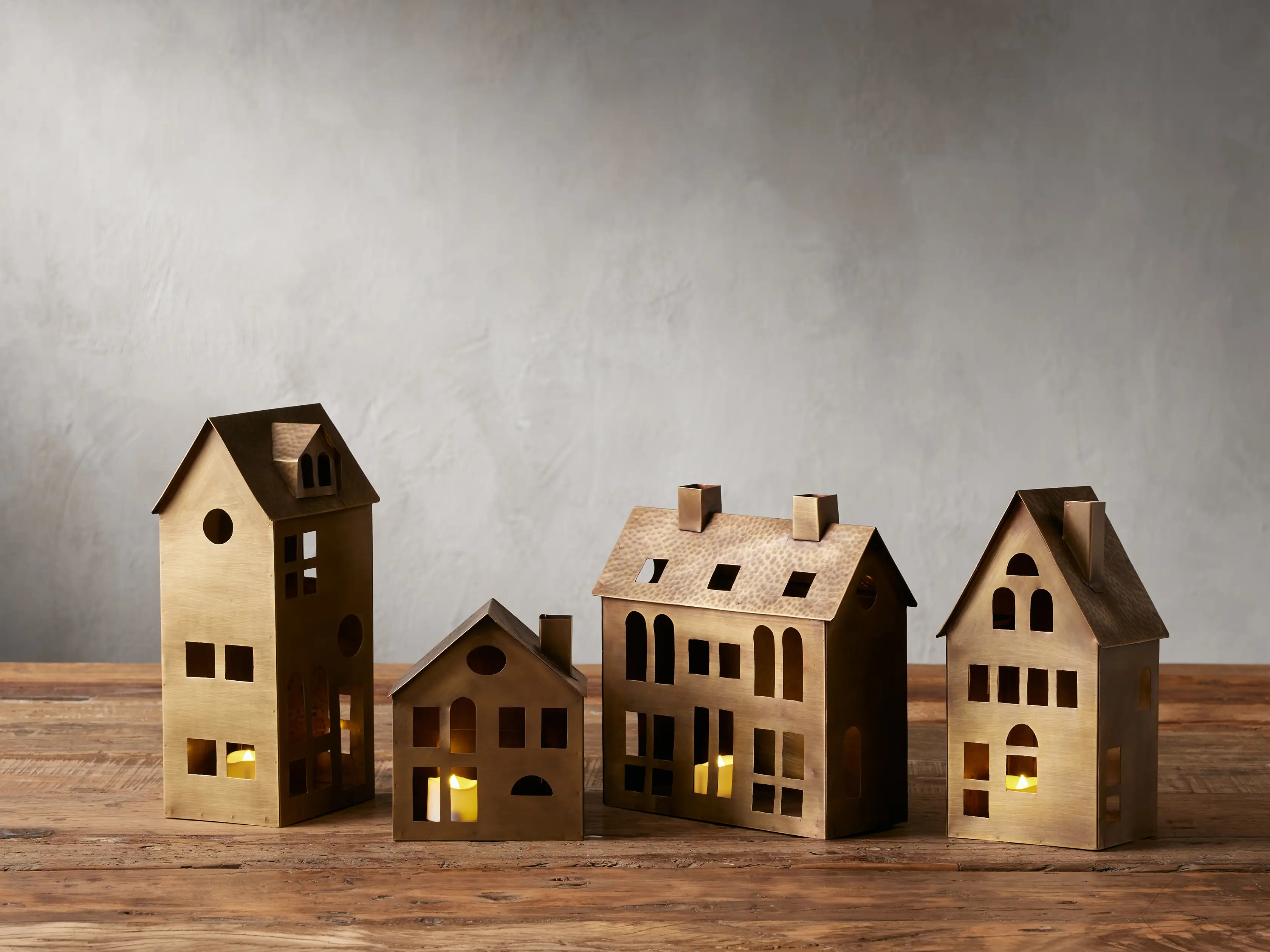 Bring charming holiday magic to your décor with our handcrafted Brass Village, featuring hand-ha... | Arhaus