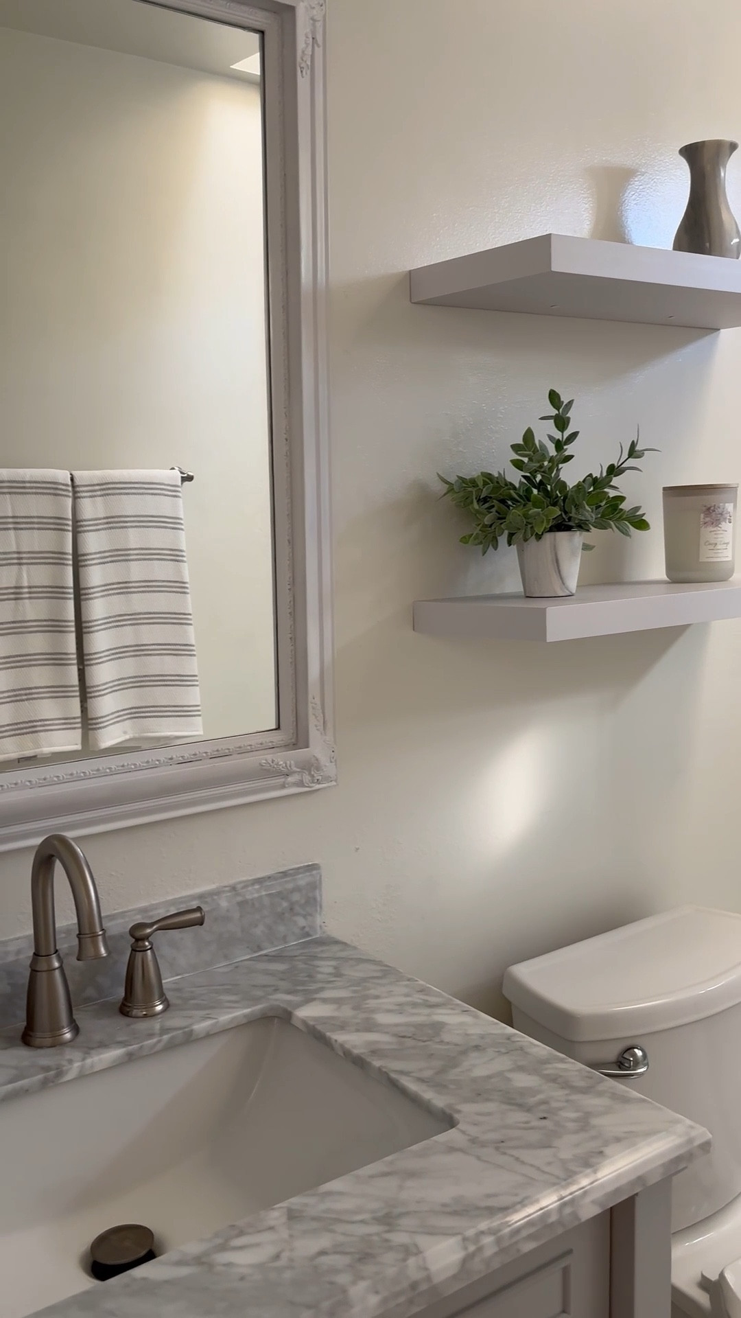 A glow up for a guest bathroom ✨
We added marble floor tile, this statement shower tile, and some shelves above the toilet.  A new vanity and mirror completed this modern traditional look.  

#LTKHome