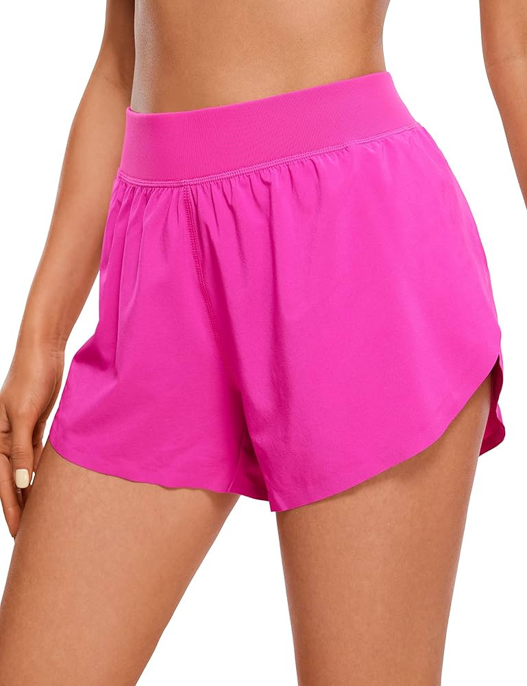 CRZ YOGA Mid Waisted Dolphin Athletic Shorts for Women Lightweight High Split Gym Workout Shorts ... | Amazon (US)