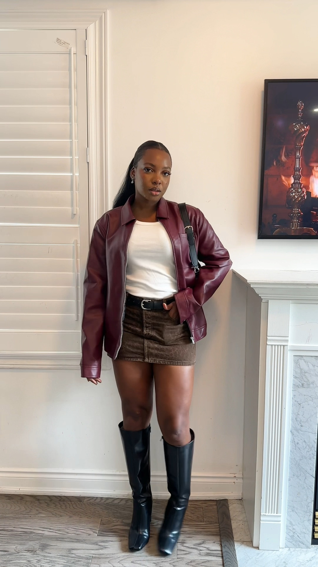 Burgundy leather jacket, animal print short skirt, white tank top, black voots

#LTKcanada