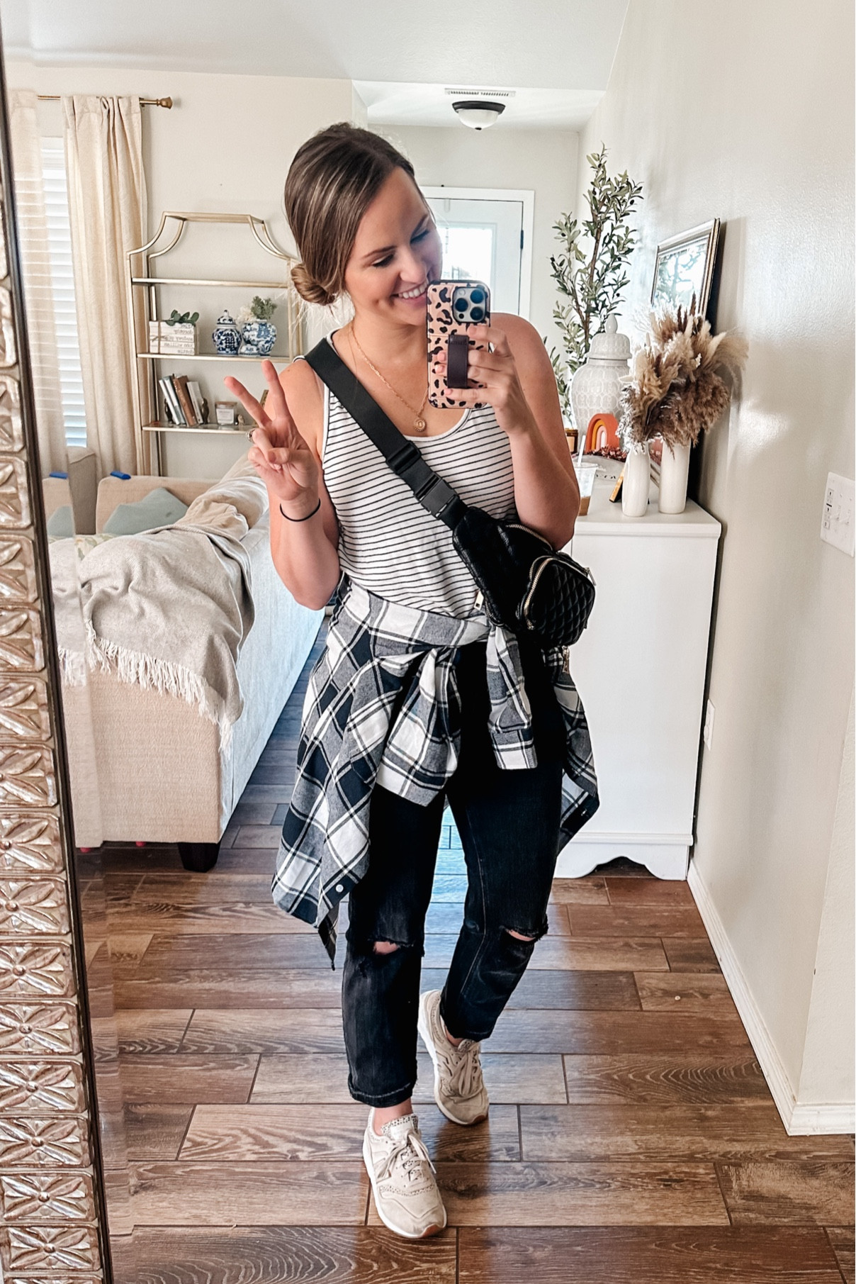 Casual mom outfit! Travel look. School pick up outfit. Belt bag from amazon. 

Wearing a M in Striped tank, size 29 in black mom Jeans, & M in navy plaid flannel (super dark- almost looks black to me). Wearing leopard neutral new balance sneakers— size a 1/2 size down. Run a little big. 

Travel outfit. Casual style. Fall outfits. Fanny pack. Diaper bag. Mom fashion. Fall fashion. 

#LTKtravel #LTKCon #LTKunder50