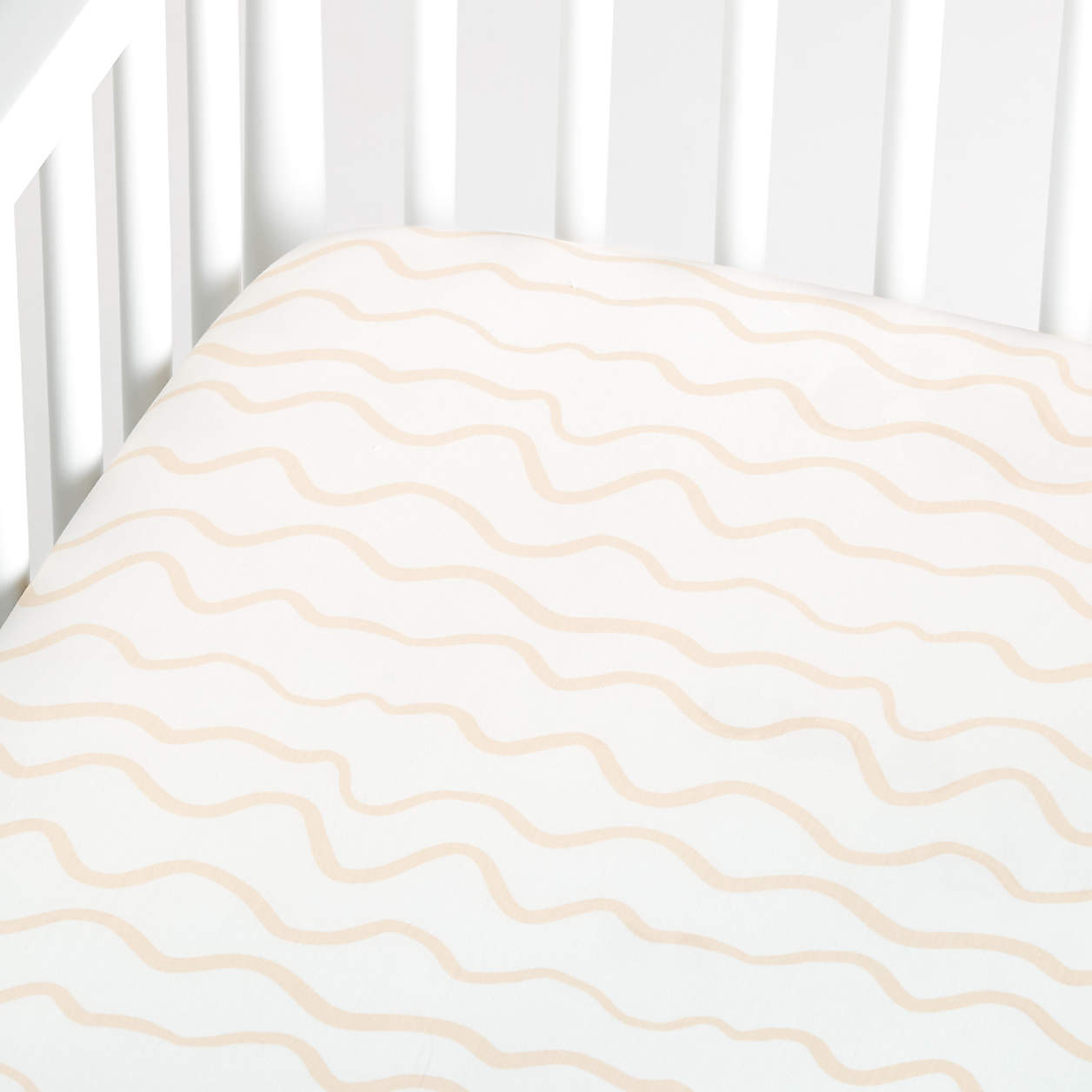 Modern Imperfect Stripe Organic Light Peach Baby Crib Fitted Sheet + Reviews | Crate & Kids | Crate & Barrel