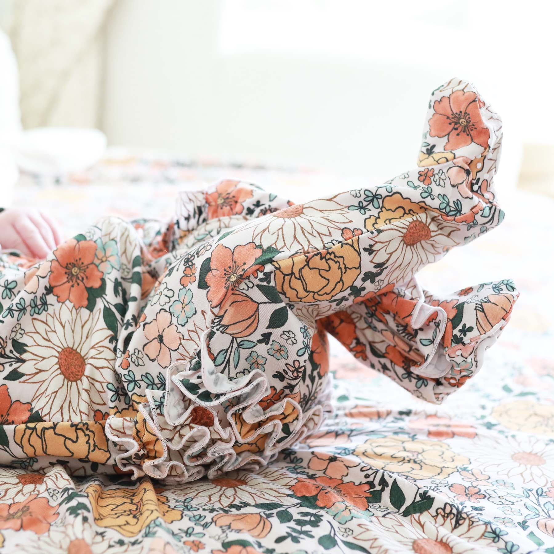 Stevie's Sunset Floral Ruffle Zipper Footie | Caden Lane