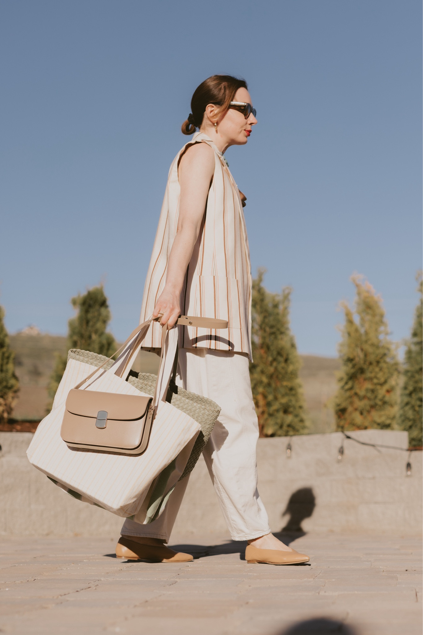 Early Summer outfit idea: white denim + parasol stripes. 
Wearing barrel leg jeans in ecru (Free People ) + silk cami in bronze color (L’Agence older collection) + sleeveless suit jacket in beige pink and brown stripes paired with a flap bag in taupe & vintage blue resin necklace (all Sézane) + Aeyde ballet flats and Bottega Veneta Cabat bag. 
I also linked a few very cute pieces I found on Amazon (all under $100 & $50) as well as Isabel Marant striped tote that’s on sale rn at Net-A-Porter! 

#LTKSaleAlert #LTKSeasonal #LTKFindsUnder100