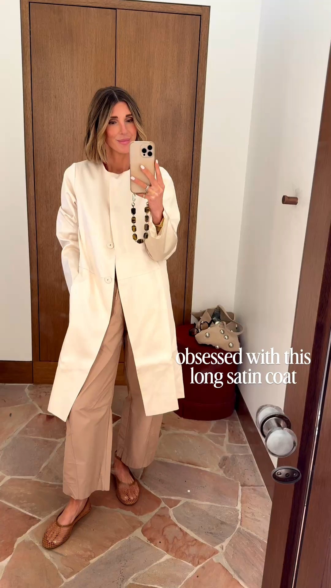 I tried on this long satin coat at reformation and absolutely loved that. I'm wearing size extra small here.