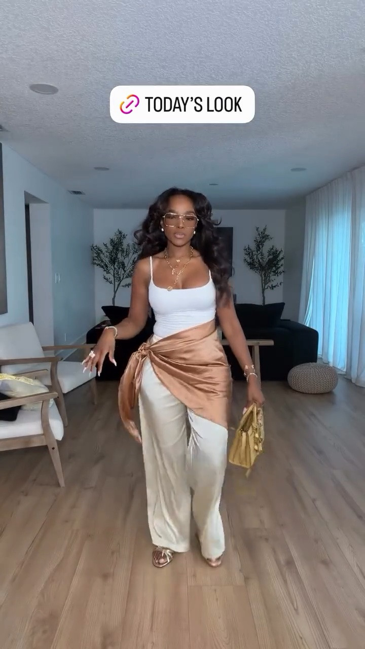 Hi Babes! 

This outfit is giving effortless luxury vacation energy in the best way 🤎 The silky wrap detail layered over the flowy cream pants instantly makes the whole look feel elevated and expensive while still looking relaxed and wearable. I love how the gold accessories and glasses pull everything together without taking away from the neutral tones.

This is one of those looks that feels styled but still comfortable enough to wear all day. The pieces can also be mixed and matched so many ways which makes the cost per wear so worth it.

Perfect for:
• Resort wear  
• Vacation dinner outfits  
• Brunch looks  
• Casual luxury styling  
• Summer date nights  
• Elevated everyday outfits  

Everything is linked below ✨

xx Kira | IG: KirasFashionFinds

34D - 27 - 40 • Size Small or 4
