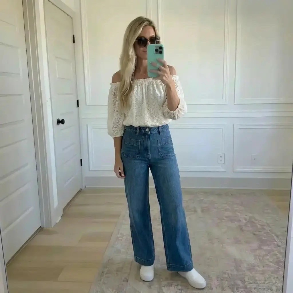 Golden natural light fills a clean, paneled room as effortless textures take center stage. A blonde woman captures a mirror selfie wearing a romantic off-the-shoulder lace blouse paired with relaxed, wide-leg denim. Finished with crisp white slip-on shoes and oversized sunglasses, the look blends softness and structure—modern femininity with an easy, everyday edge. Neutral tones, airy fabrics, and timeless denim create a quietly confident, lived-in aesthetic.

Hashtags
#EffortlessChic #SoftAndStrong #LaceTop
#WideLegDenim #ModernFeminine
#EverydayStyle #NeutralAesthetic
#CasualPolished #MirrorStyle
#TimelessDenim #QuietLuxury
#SimpleOutfit #StyleInspo

#LTKdayinmylife #LTKValentine #LTKgrwm
