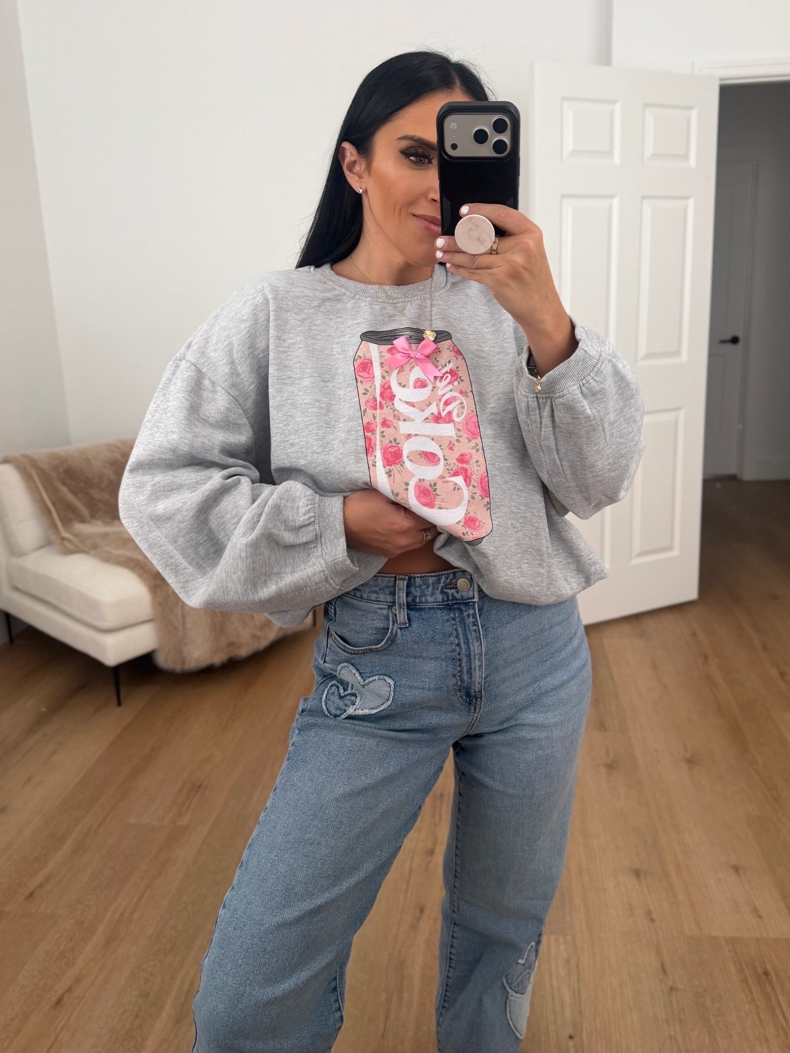 No Boundaries High Rise Baggy Wide Leg Jeans with Heart Patch wearing size small. Coca-Cola Women's Diet Coke Floral Graphic Crewneck Sweatshirt wearing size medium. 