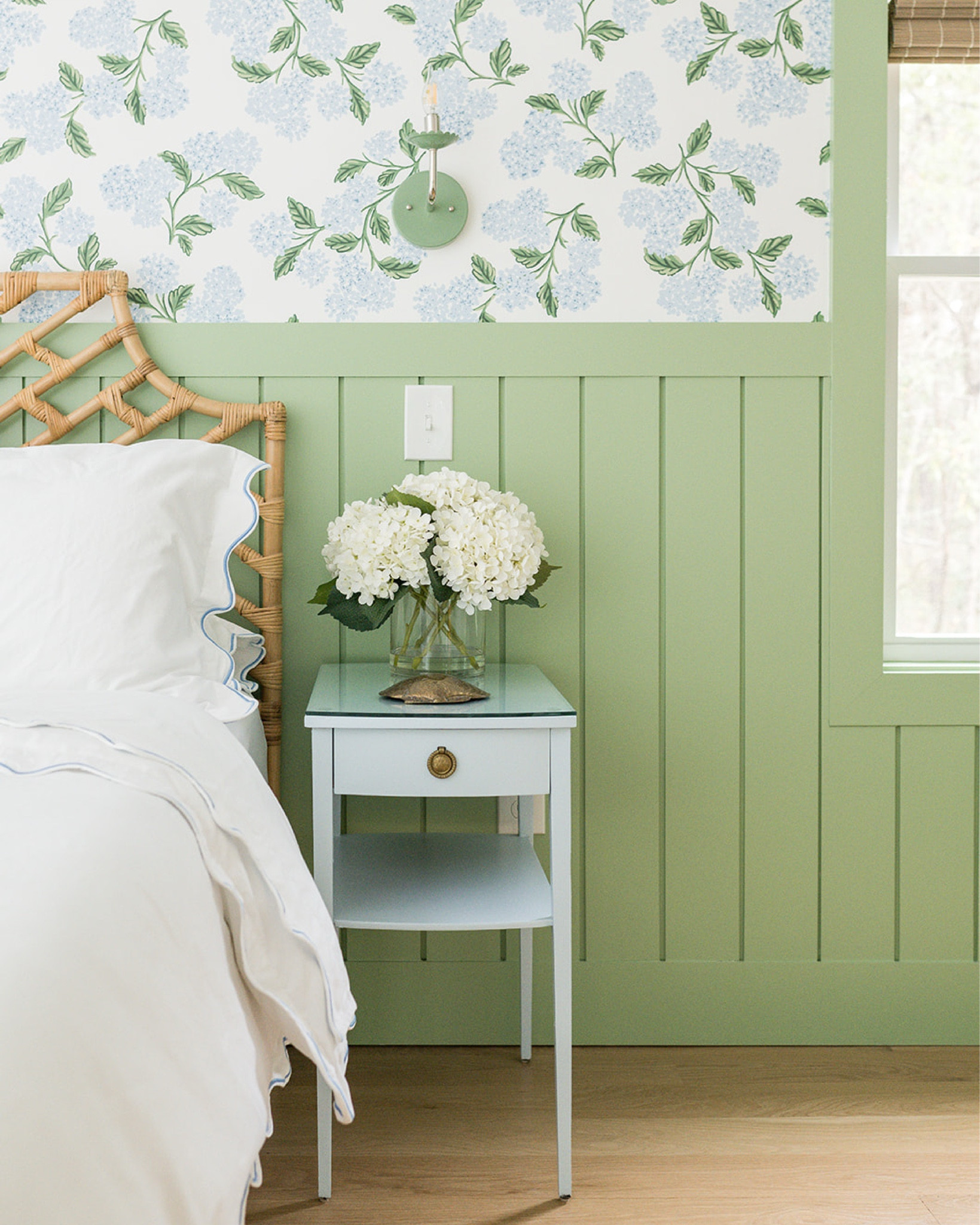 first up is the primary bedroom at the #preppyhollowhouse! we love this cheerful combination of hydrangea wallpaper from @riflepaperco paired with soft green paint for the trim and wall paneling…hydrangeas are a Cape Cod classic! a rattan headboard, vintage nightstands, and green sconces complete the look. #dwelloctoberstay #dwelloctober

#LTKHome
