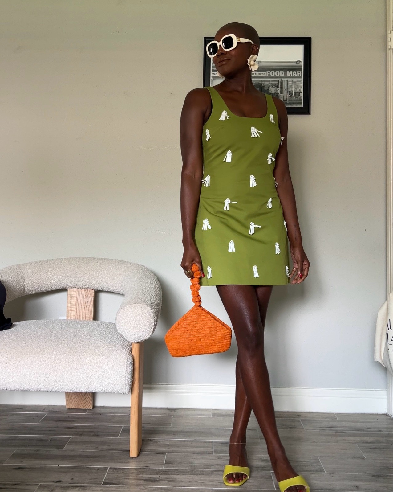 Green mini dress with white sand dollar appliqué details, orange raffia wrist bag and flower earrings.

#LTKootd