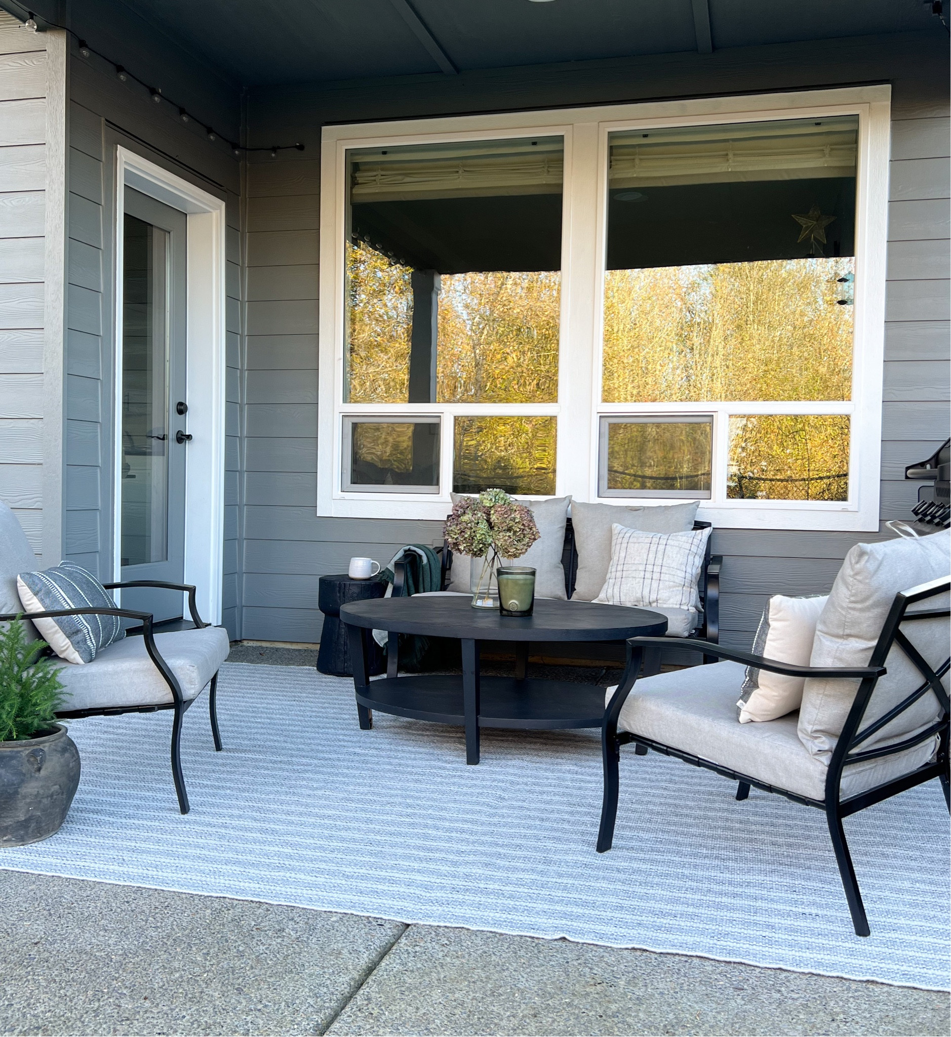 Fall/winter patio styling, candle, throw pillows, rug, string lights, found pot, end table

#LTKhome #LTKSeasonal