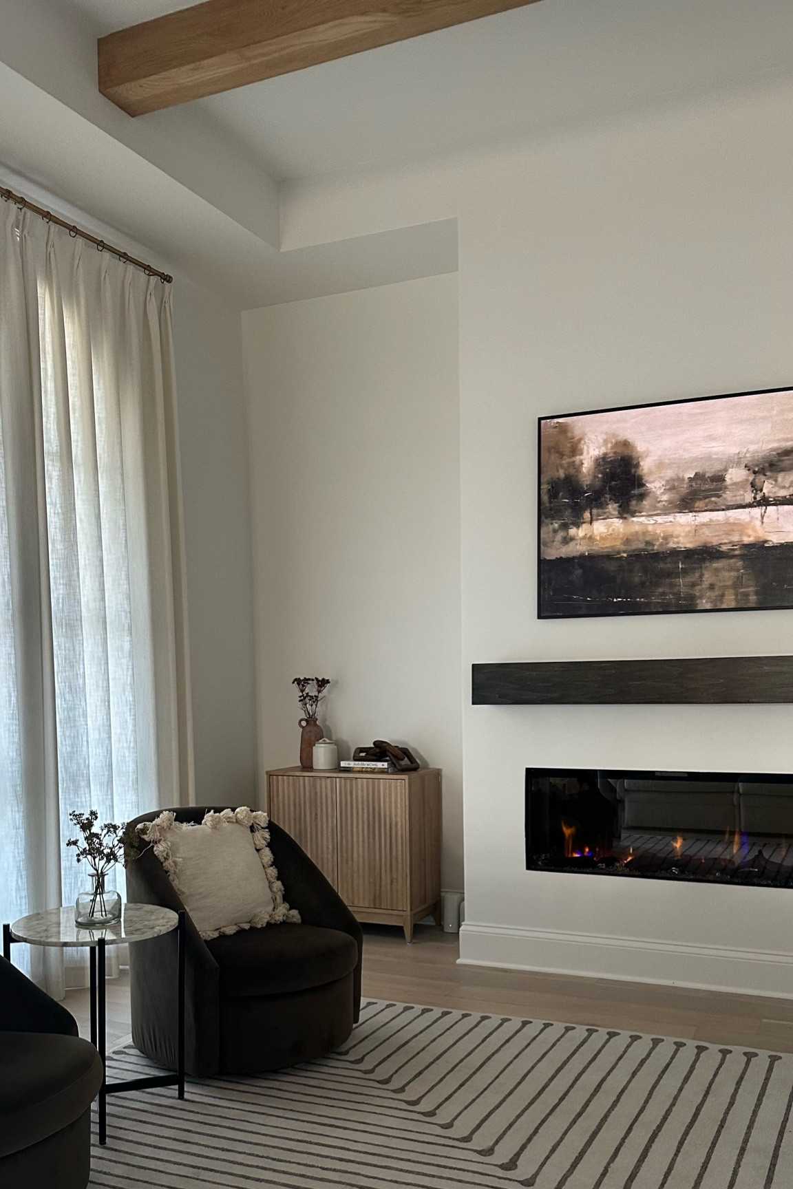 Accent table, accent chair, electric fireplace, frame TV art, side table, drapes 

#LTKhome