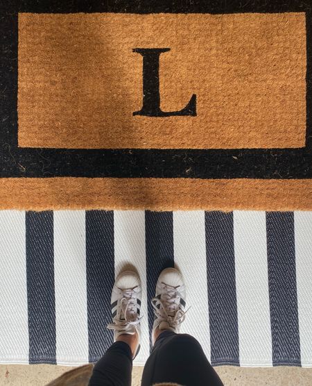 Front porch essentials. Layer you area rugs and doormat to make your entryway stand out. I used a monogrammed coir doormat and a striped outdoor area rug underneath. 

#LTKSeasonal #LTKfindsunder50 #LTKhome