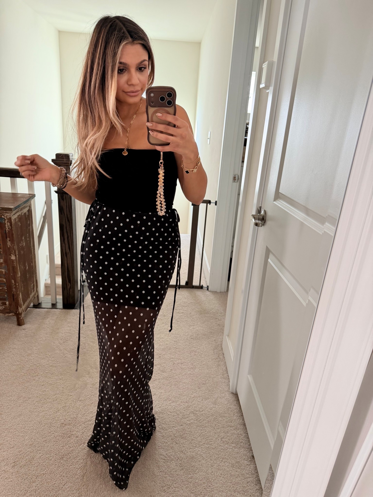 Polka dot skirt over a black 
Strapless dress 
So cute for summer 

#LTKdayinmylife #LTKootd #LTKgrwm
