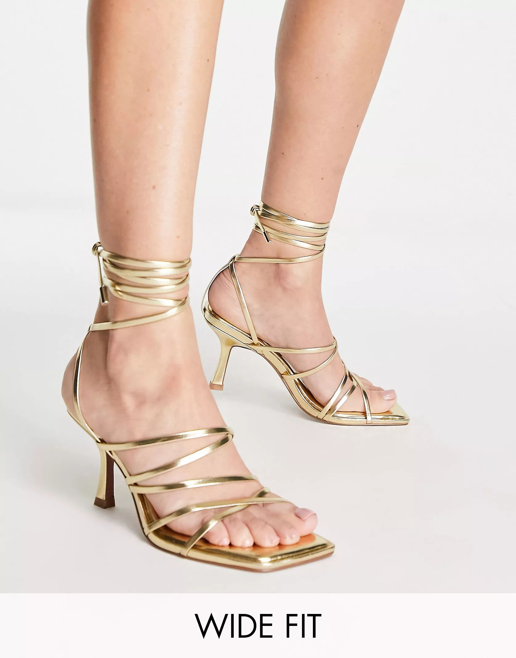 ASOS DESIGN Wide Fit Hiccup strappy tie leg mid heeled sandals in gold | ASOS (Global)