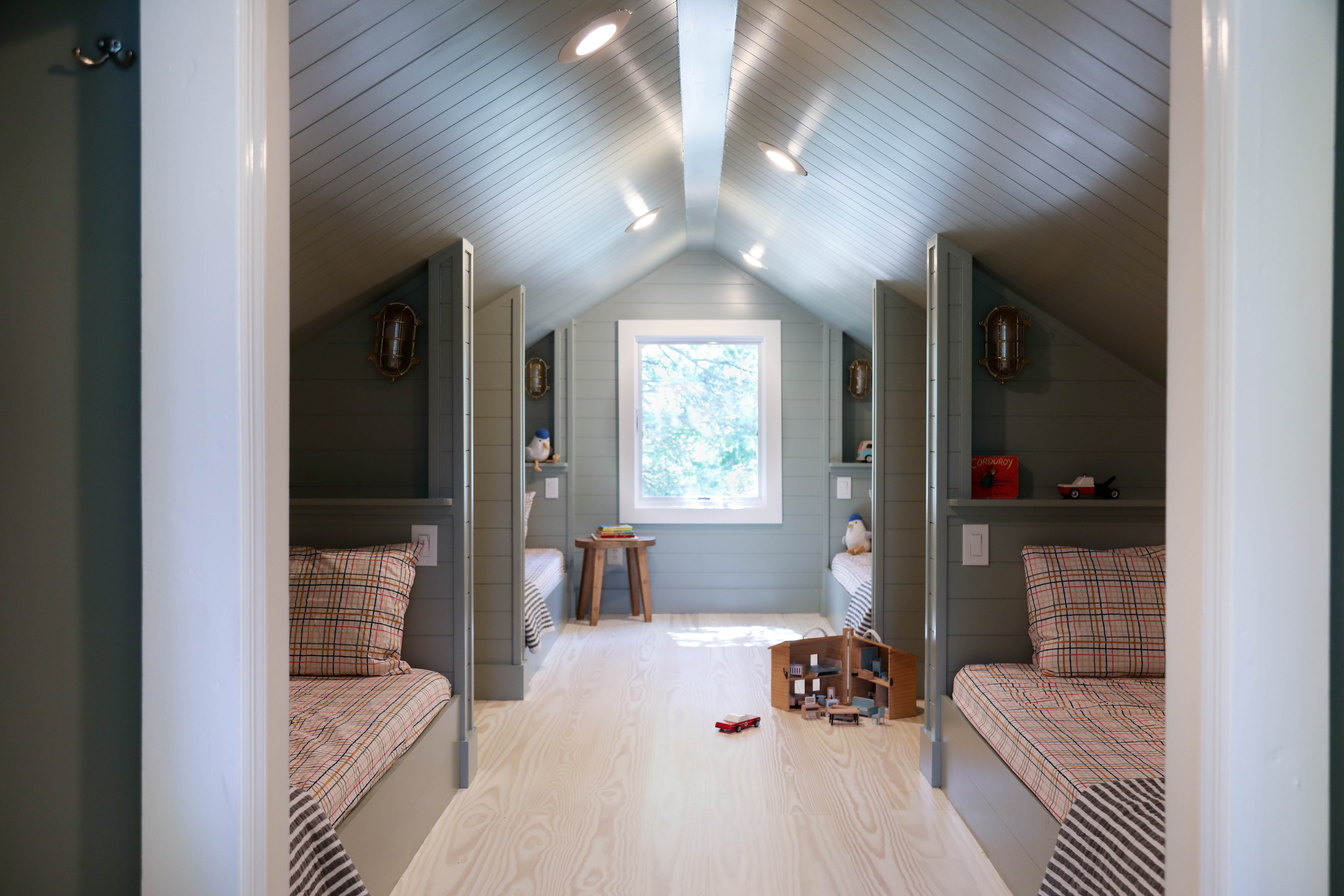 Built-in bunk room with a budget-friendly shiplap alternative, plaid Target sheets, and simple wood stools. For the beds, we used metal bed frames wrapped in wood instead of building fully custom bunks from scratch, which reduced both labor and material costs. Added lookalike lighting and similar decor pieces throughout the room. Linking exact and similar pieces here.

#LTKHome #LTKSaleAlert