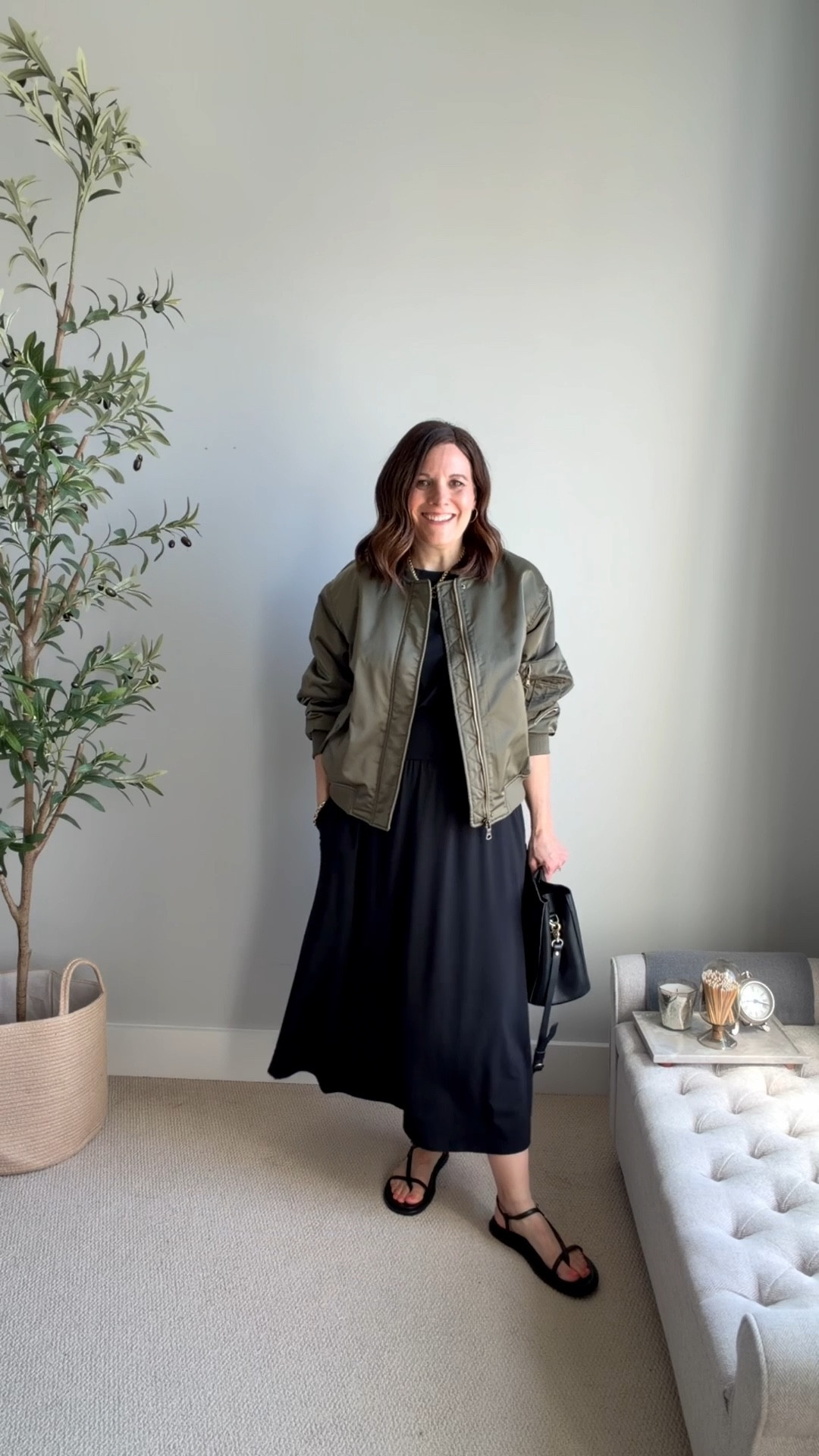 I’m surprised by how much I love this outfit and this jacket (it’s perfect for a cool morning or evening). This olive bomber jacket has a slight sheen and a relaxed fit, adding an edge to the outfit. Pushing up the sleeves draws the eye to the waist and adds to the laid-back feel. Simple black sandals and a black bucket bag finish the look. I’m wearing this jacket in a small, it fits big, and the dress in a small (tts).


#LTKOver40 #LTKSaleAlert #LTKMidsize
