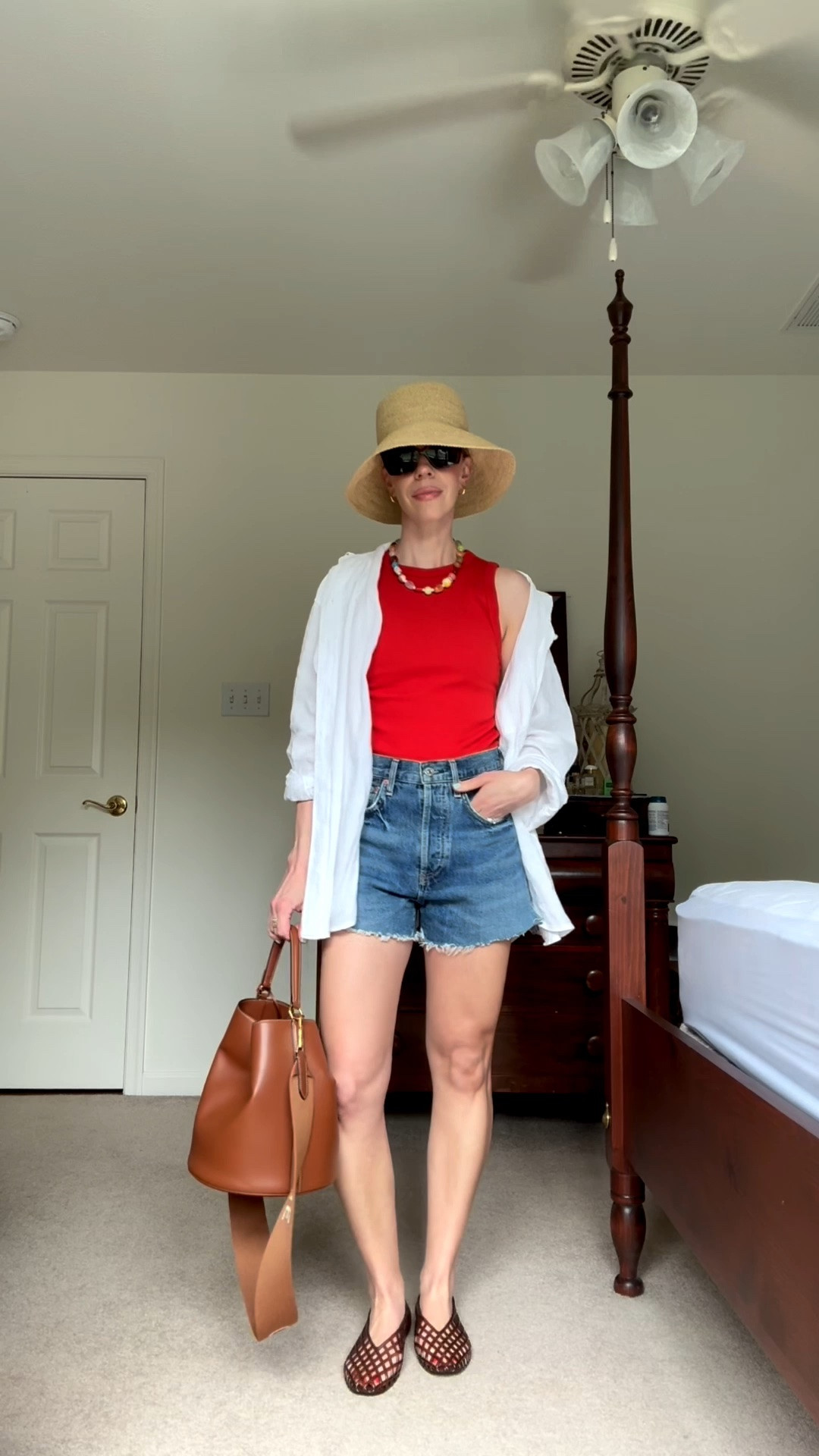 Casual summer outfit with red tank, cutoff denim shorts, linen shirt, jelly shoes, @Janessa Leone straw bucket hat

#LTKSeasonal #LTKOver40 #LTKSaleAlert