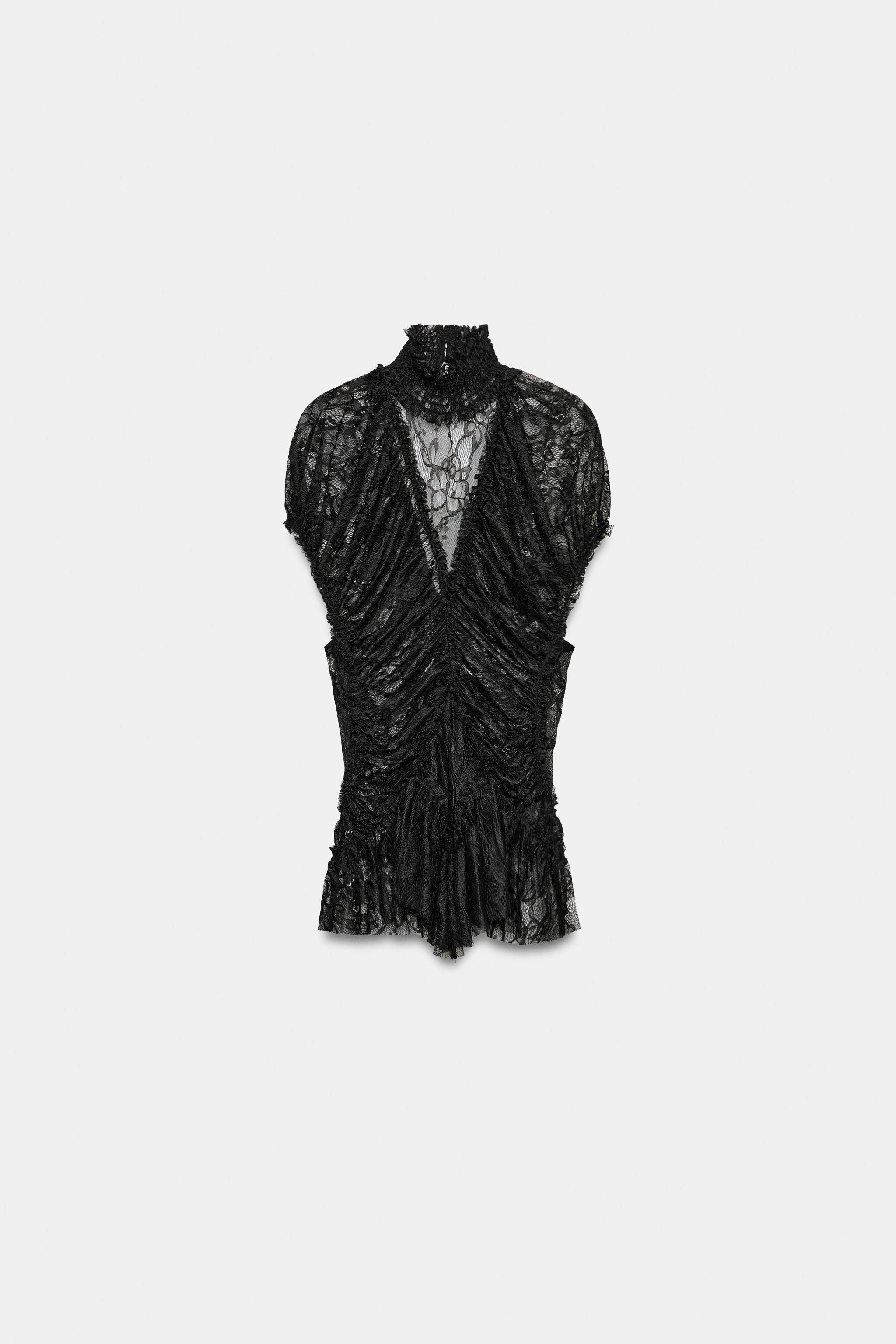Model height: 175 cmTop crafted from semi-sheer fabric. Featuring a high neck, short sleeves, ela... | Zara UK