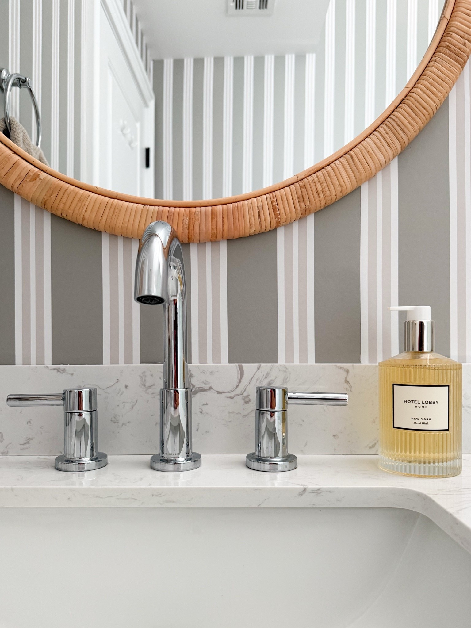 The mix of polished chrome and woven texture makes this bathroom feel clean but still warm. I love how the rattan mirror softens the striped wallpaper and adds just enough contrast to the marble vanity.

bathroom mirror, rattan mirror, striped wallpaper, bathroom vanity, chrome bathroom fixtures, powder room decor, bathroom styling, woven home accents, classic bathroom design, neutral bathroom decor, timeless interiors, girlonthehudson

#LTKdayinmylife #LTKSeasonal #LTKHome
