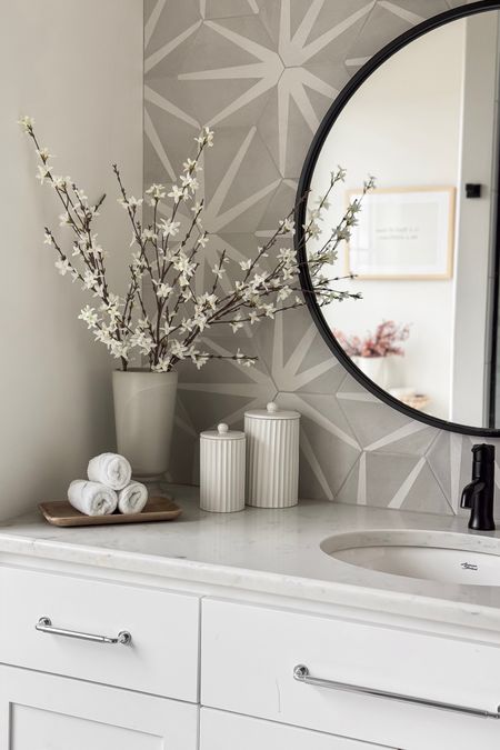 These faux blossom branches brighten up this space beautifully - perfect for spring!

Home  Home decor  Spring  Spring Home  Spring Home decor  Faux florals  Flowers  Blossom branch  Neutral  Accent wall  Tile  Wooden tray  Canisters  Mirror

#LTKhome #LTKSeasonal #LTKstyletip