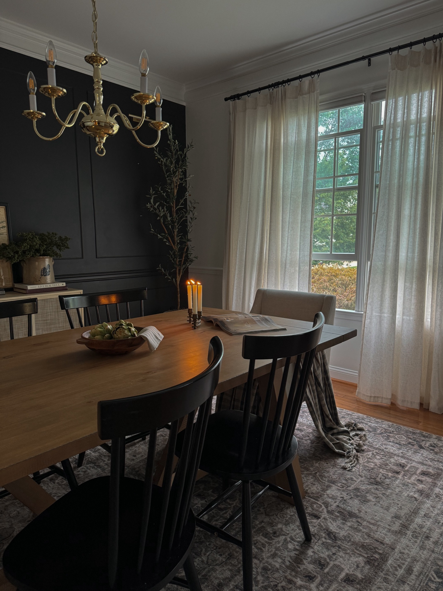 Moody dining room, dining table, dining chair, accent chair, pleated curtains, Amazon curtains, black accent wall, dining room rug, olive tree

#LTKHome