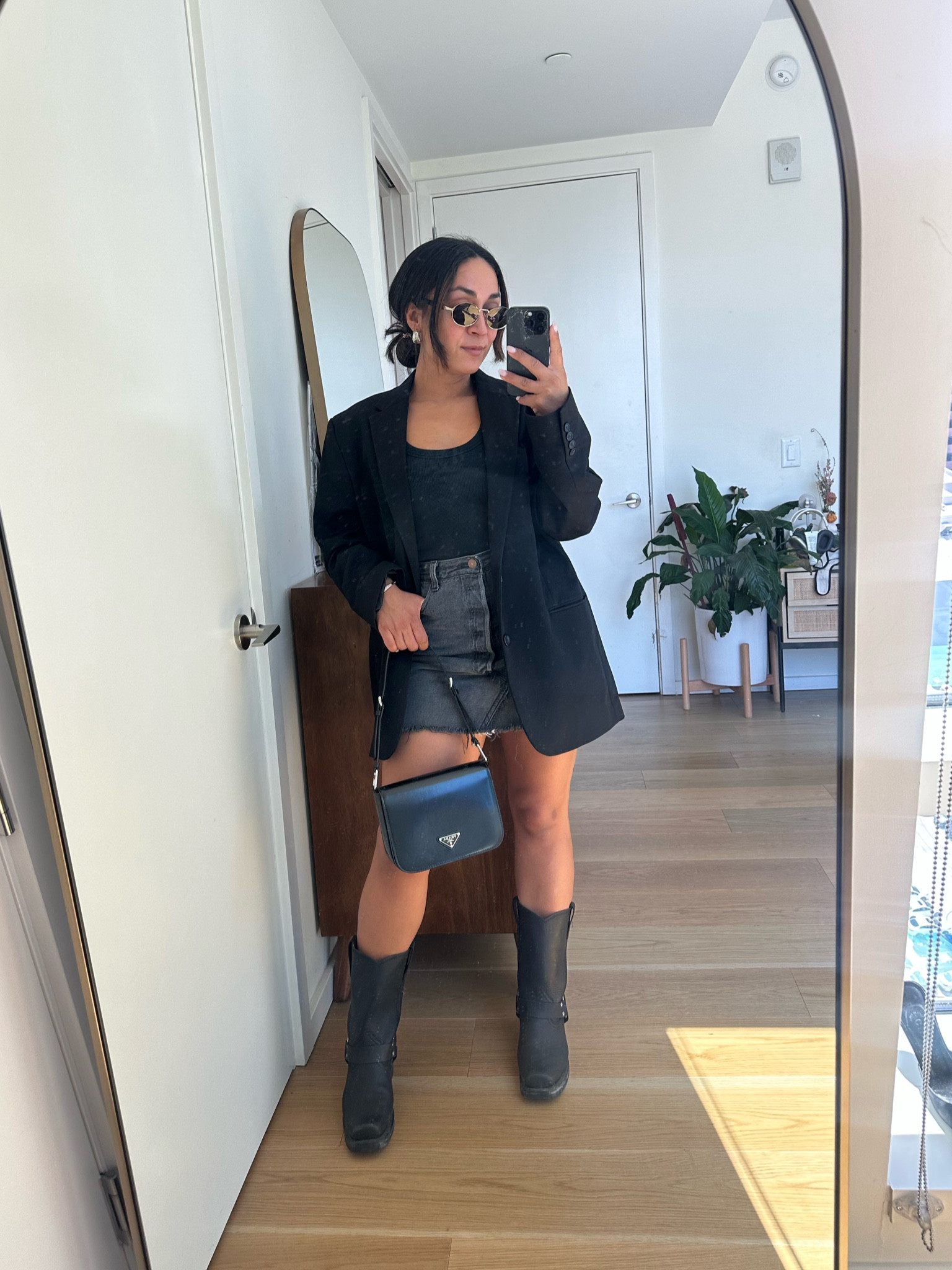 Transitional fall outfit: Oversized blazer, denim skirt, and tee with boots outfit. 