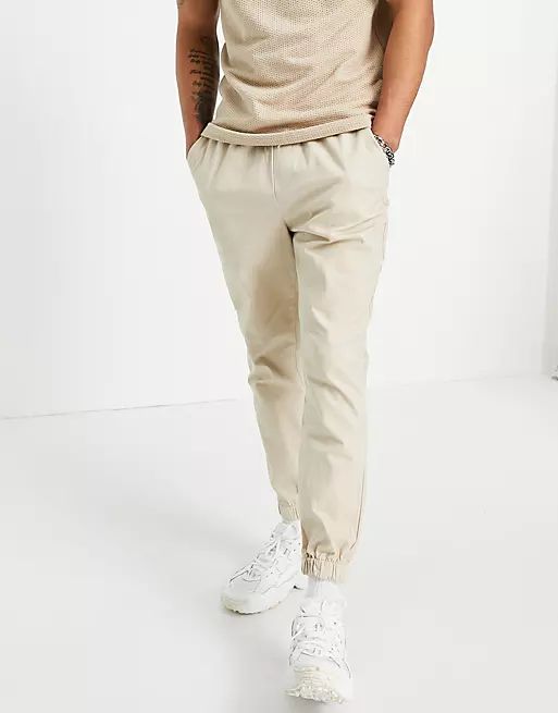 ASOS DESIGN tapered chino sweatpants with elasticated waist in beige | ASOS (Global)