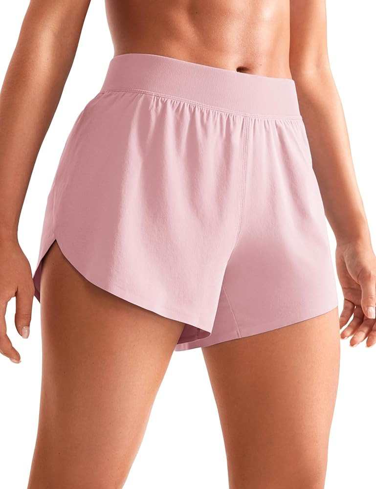 CRZ YOGA Mid Waisted Dolphin Athletic Shorts for Women Lightweight High Split Gym Workout Shorts ... | Amazon (US)