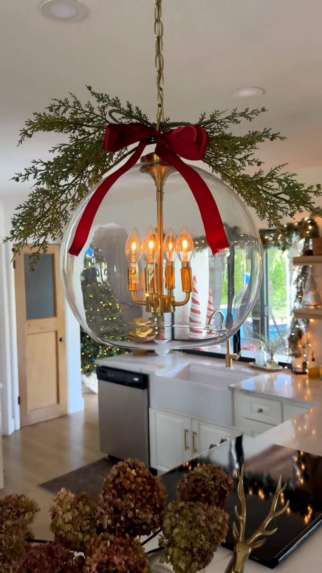 Christmas kitchen island and chandelier! Love adding this festive touch to our island and pendant lights. The red bows bring everything together. Winter Stems are from Hobby Lobby. 

Garland 
Winter stems 
Now
Red now 
Vintage Christmas 
Kitchen Christmas 
Pottery barn 
Walmart 
Target
McGee and co 
Magnolia 
My Texas house 
Reindeer 
Holiday 
Kitchen 

#LTKHome #LTKSeasonal #LTKHoliday