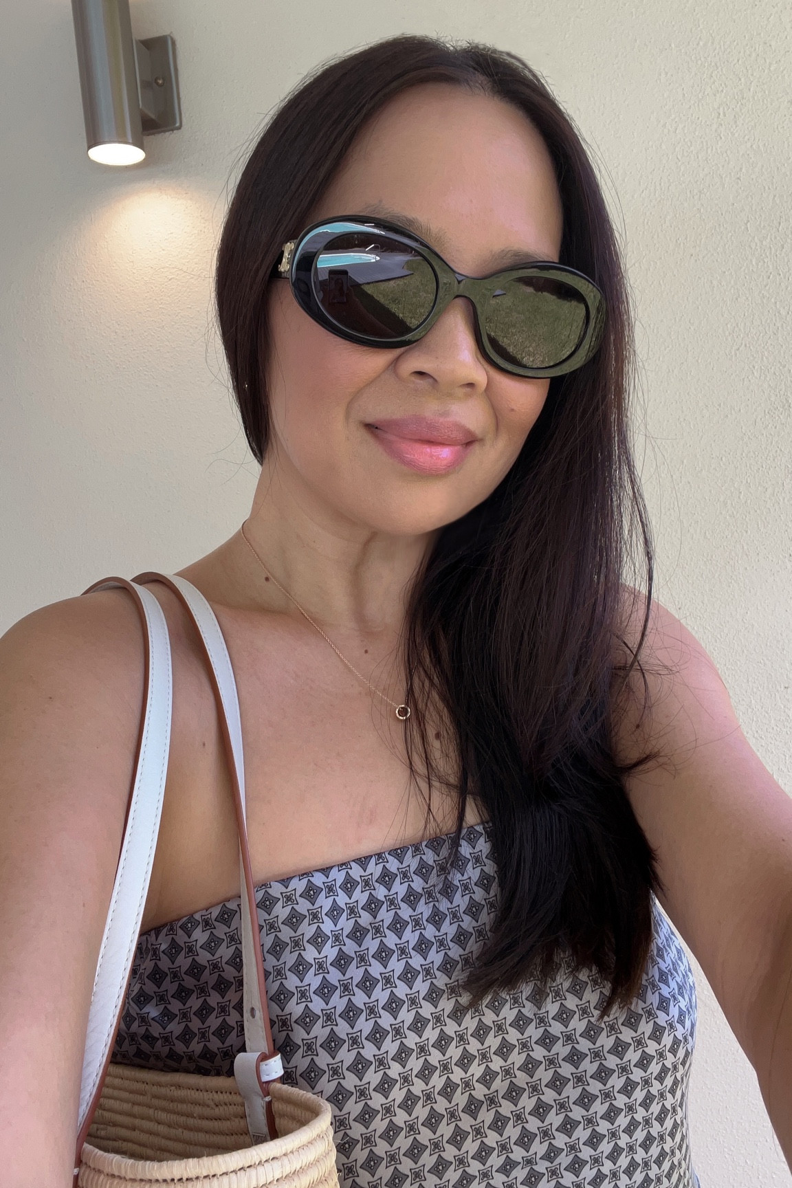 Celine Sunnies, Reformation Silk Top, Loewe Raffia Bag