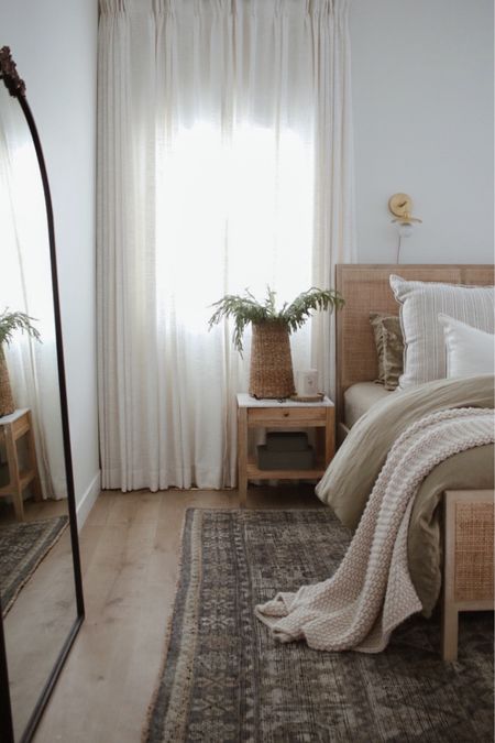 Primary bedroom, nightstand, bedding, bed, wood bed, wall sconce, arched mirror, area rug, linen sheets, bed throw, interior decor 

#LTKhome #LTKstyletip #LTKsalealert