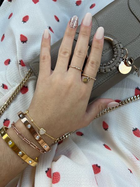 Impress press-on nails, cartier lookalike Amazon rhinestone bangle bracelets, rose gold paperclip chain bracelet, Adina Eden bracelet mother of pearl hearts, gold jewelry, See by Chloe crossbody bag, strawberry print smocked dress from Macy’s. Xoxo! #LTKFind #LTKitbag #LTKbeauty #LTKGiftGuide 

#LTKstyletip #LTKtravel #LTKsalealert