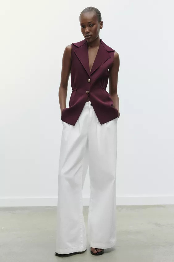 Plain knit waistcoat with a lapel collar and sleeveless design. Featuring elasticated gathers at ... | Zara UK