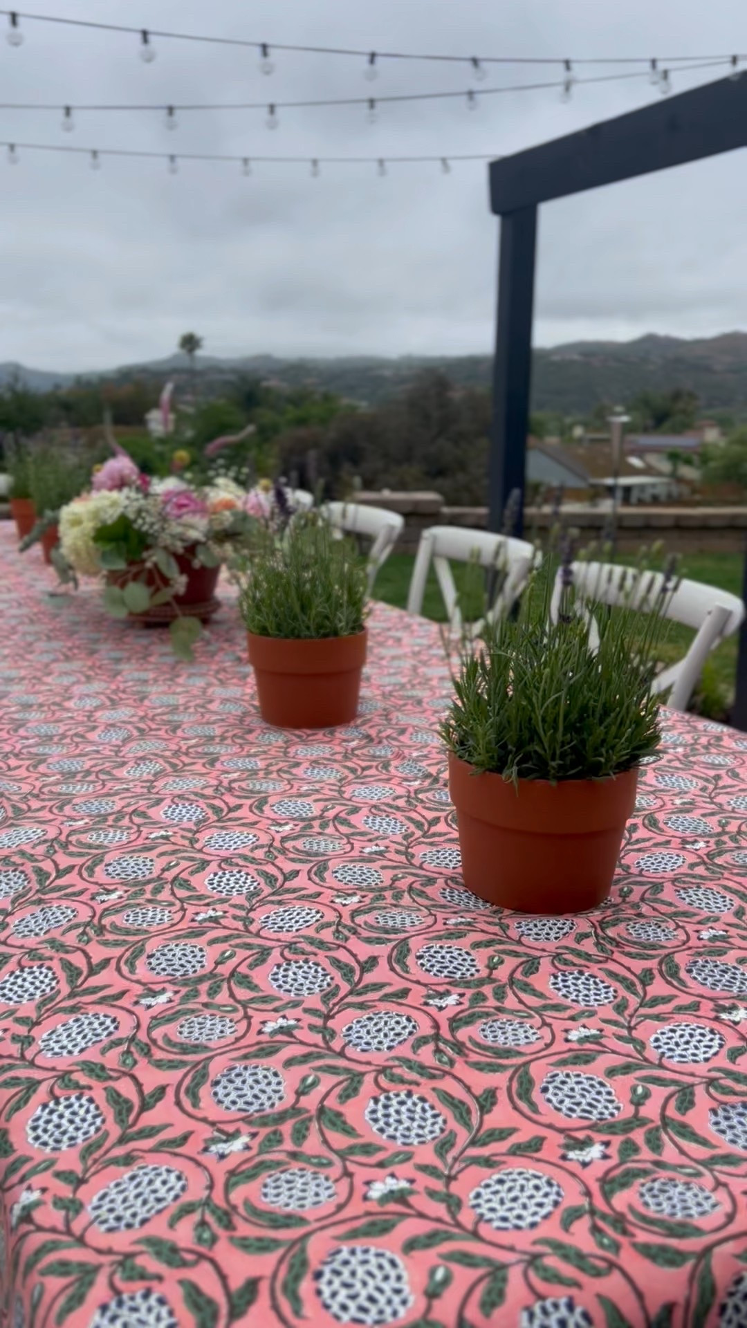 A simple alfresco table setup that anyone can pull together 🌿✨

We hosted outdoors and wanted the vibe to feel laid-back but still pretty. A patterned tablecloth instantly made it feel special (this one comes in a variety of sizes and colors), and I used inexpensive terracotta pots with lavender for an easy, low-maintenance centerpiece. Bonus: they smell amazing and double as take-home gifts.

The floral arrangements? Trader Joe’s haul—under $100 for everything, and I made three arrangements in about 30 minutes.

This is proof you don’t need a florist or a fancy event team to create something beautiful. Just a few thoughtful details, a pop of color, and some fresh air.

#outdoortablescape #alfrescotable #easytablescape #simpletablescape #budgetdecor #outdoorentertaining #patiodining #traderjoesflowers #lavenderpots #tablesettingideas #springtablescape #summerentertaining #ltkhome #backyardpartyideas #hostwithstyle #casualhosting

#LTKSummerEdit #LTKSeasonal #LTKHome
